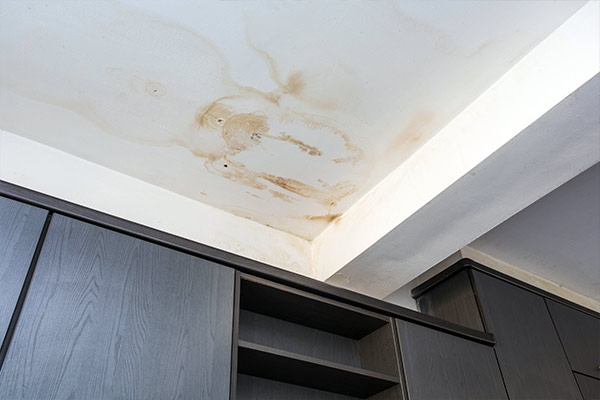 a ceiling with stains from a roof leak above